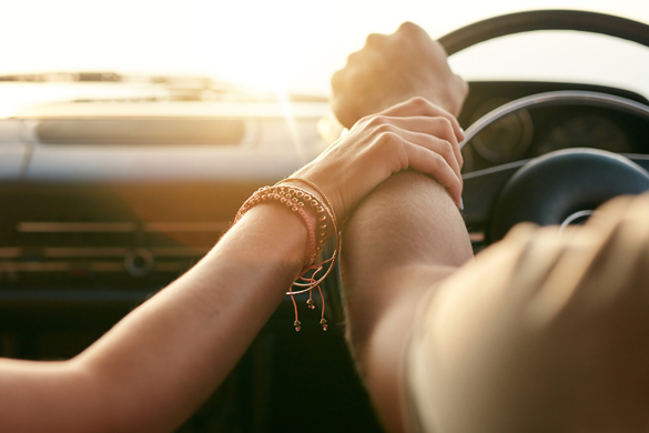 close-up-shot-of-loving-virgo-man-and-taurus-woman-traveling-by-car-and-holding-hands
