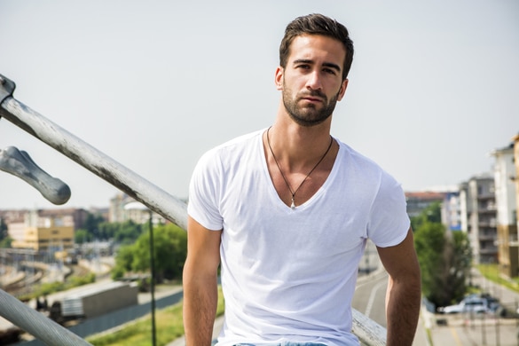 handsome-bearded-young-virgo-man-outdoors-in-urban-environment-looking-at-camera