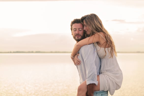 portrait-of-a-gemini-woman-embracing-her-virgo-man-from-behind-on-sunset