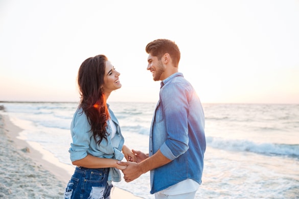 virgo-man-and-aquarius-woman-holding-hands-and-laughing-on-the-beach